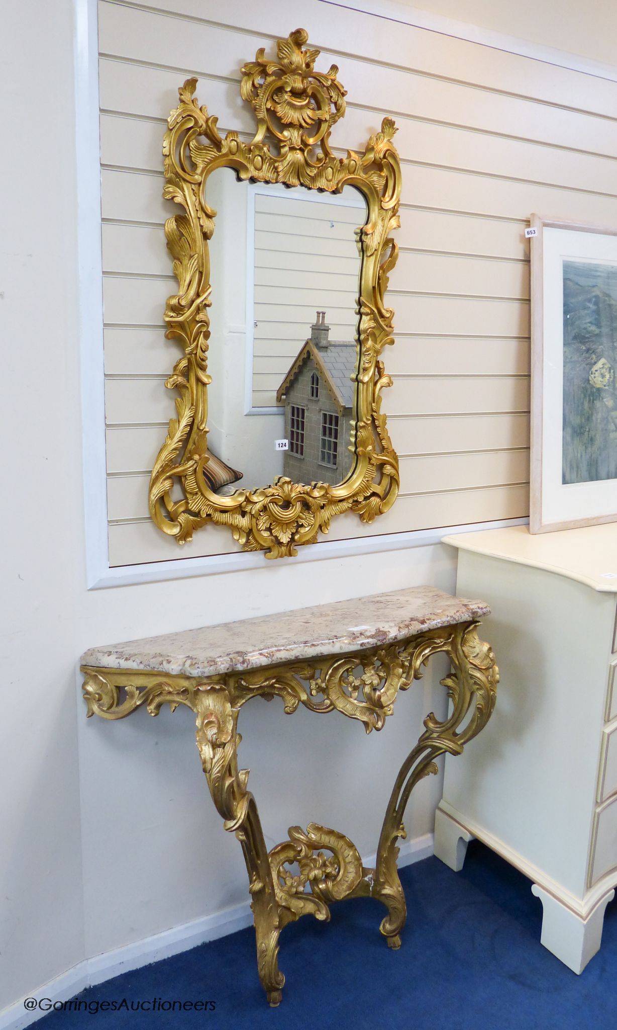 A 19th century rococo revival giltwood console table, 95cm wide, 86.5cm high and a similar later giltwood mirror, 113cm high, 64.5cm wide